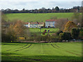 Green fields sloping down to Clay Lane