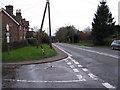 Road junction between Mill Lane on the left and Long Hill (A281)