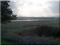 The sun shining on the Thames Estuary beyond Canvey Island