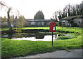 Postbox by pond at High Common