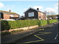 Lop sided sign in Redwing Road approaching Petersgate Infant School