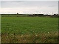 View across farmland towards a ruined mill above Sheepland Harbour