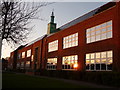 Charminster: evening sun reflected in Bournemouth School