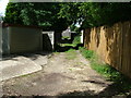 Round the back of houses in Green Lane & Handcross Grove.