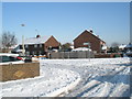 Approaching the junction of a snowy Grateley Crescent and Crookham Close