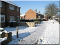 Approaching the junction of  a snowy Middle Park Way and Thruxton Road