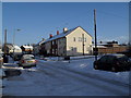 Approaching the junction of  a snowy Ellisfield Road and Blackdown Crescent