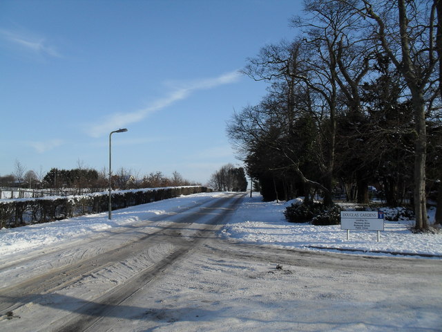 Junction of a snowy Martin Road and Douglas Gardens