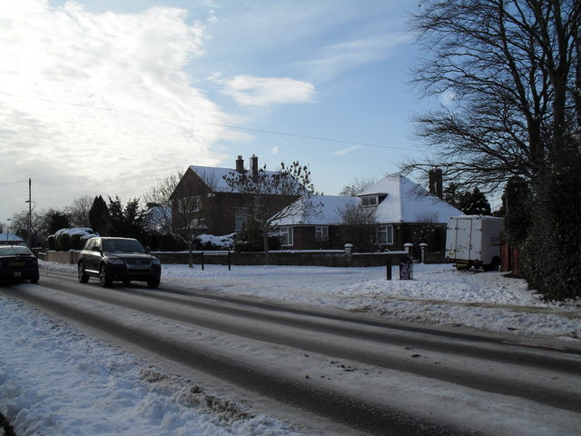 Approaching the junction of a snowy Southleigh Road and Berkeley Square