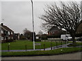 Looking across from Harsfold Road over a small green  towards Cove Road