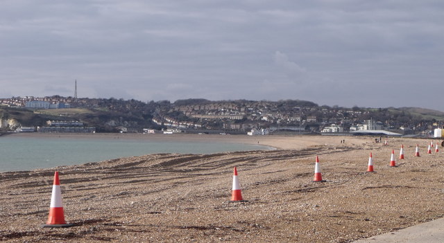 A row of traffic cones on the beach at Bishopstone, East Sussex