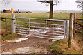 Bridleway gate with Calcutt House Farm in the distance