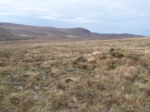 Peat covered cairn on featureless moorland hillside in Strath Chailleach