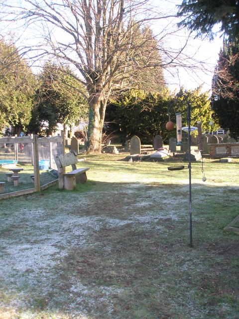 Seat in a frosty churchyard at St Stephen's, Shottermill