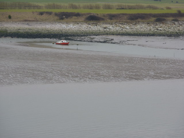 Red boat on mud flats
