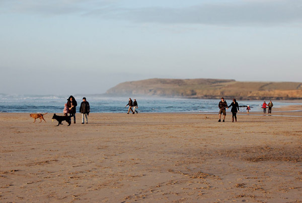 Group on Gwithian beach in evening light