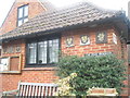 Celebratory plaques on the village hall at Churt