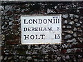 Mileage sign on wall, Holt Road (B1110), North Elmham