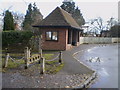 The village stocks and the bus stop in Norton