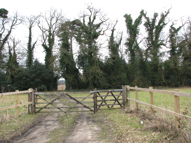 Gated farm track opposite Thickthorn Farm
