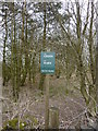 Small green notice in a small copse