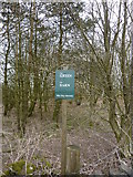 SK1468 : Small green notice in a small copse by Peter Barr