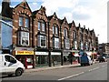 Sidwell Street: terrace of shops with carved brick facade