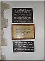 Plaques on the west wall at St Mary, Easebourne