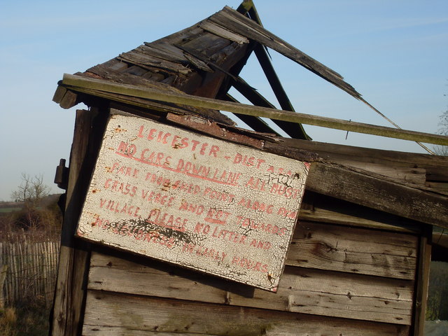 Sign on a tumbledown angling club building