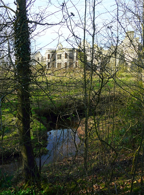 Shell of Kirklinton Hall seen through trees