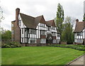 Mock-Tudor flats round a lawn, Monks Drive