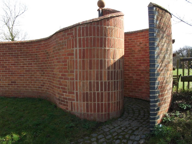 Crinkle-crankle or serpentine wall and curved gateway to private gardens