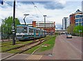 Manchester Metrolink tram no. 1022 heading for Harbour City tram stop, Salford Quays