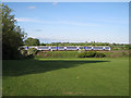 Train passing golf practice ground