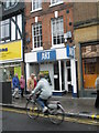 Cycling past "Art" in Salisbury High Street