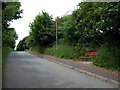 Red bench by the road