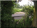 Footpath crosses Stone Street near Oast House Farm