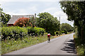 Cyclist passes Highwood Cottage