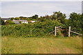 A stile marks the last leg of the footpath from Damage Barton to Higher Warcombe