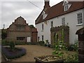 Binham: Manor Farm and its pretty dutch-gabled cottage