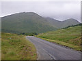 NM6432 : Looking along the A849 at big peaks by C Michael Hogan