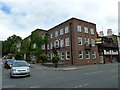 Ivy clad building at the junction of West Street and The Hart