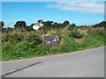 The remains of a mik churn stand opposite the Lleiniau road