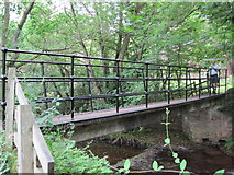 NY9357 : Footbridge over Devil's Water by Les Hull