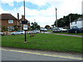 Looking from Gardner Road across a green towards Queens Road