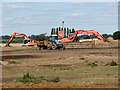 Diggers and a tractor parked in field west of Stanton