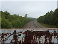 Two railway lines from a rusty footbridge