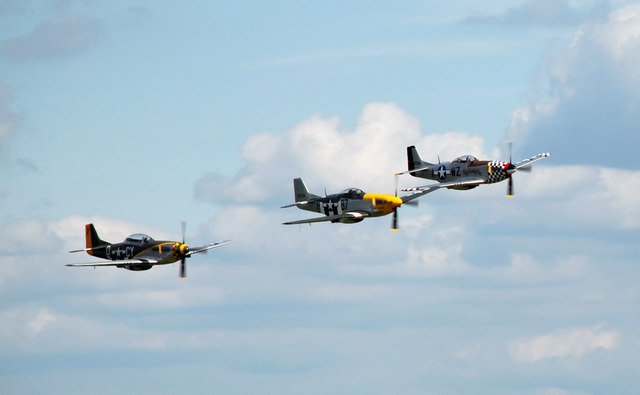 Three P-51 Mustangs in close formation over Duxford