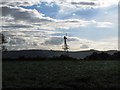 TQ4015 : Silhouette of windpump next to Blunt's Wood by Dave Spicer