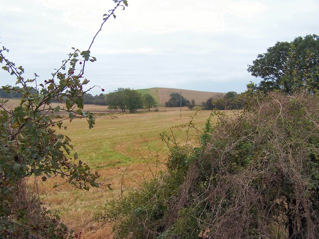 Looking through stubble field to Balig Hill
